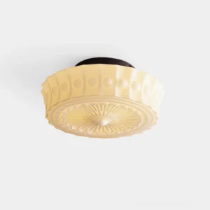 Jeevika textured glass flush mount ceiling light with embossed radial pattern and black metal canopy, front studio view