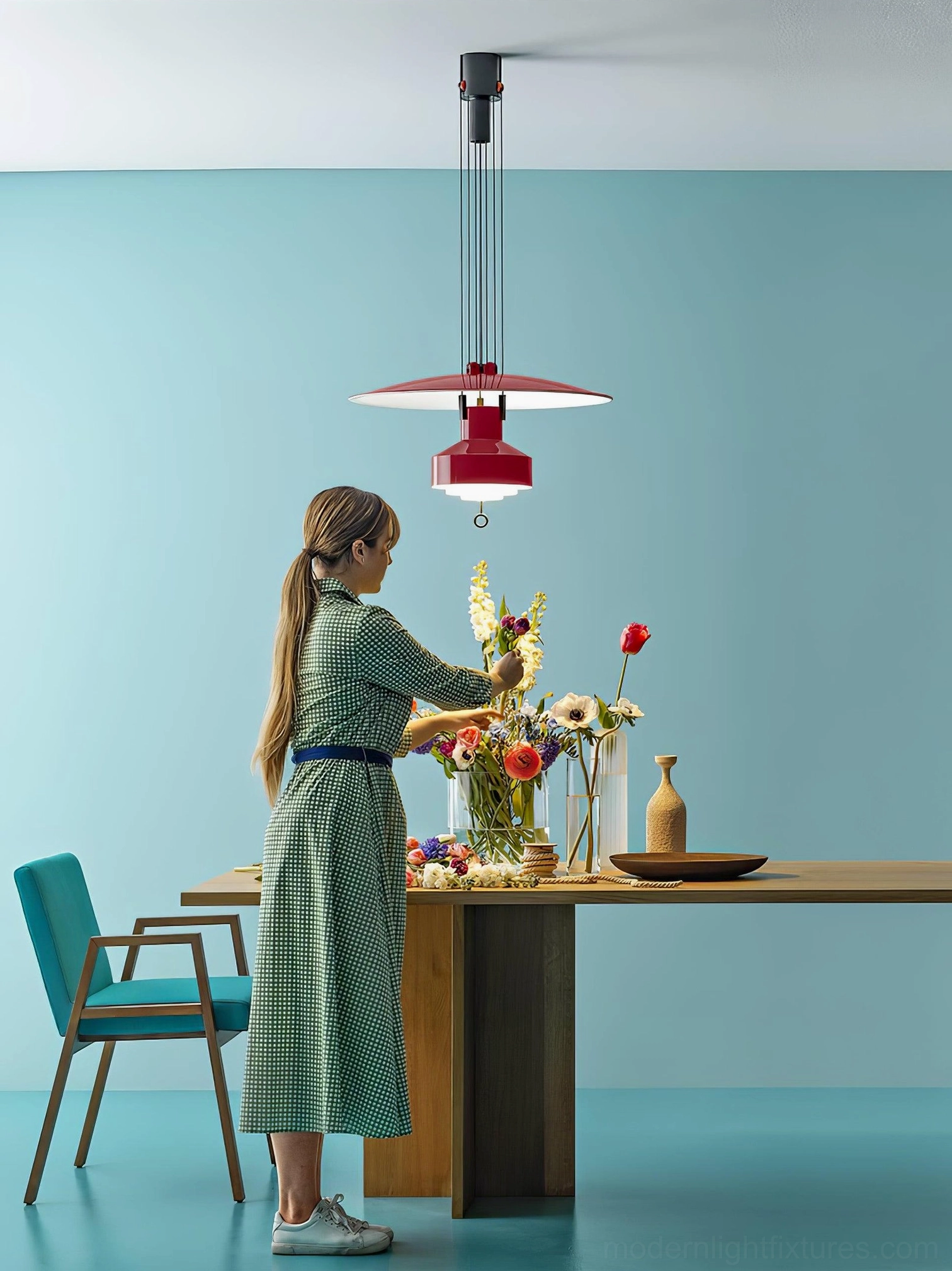 Modern green disc pendant lamp as sculptural statement piece in minimalist interior