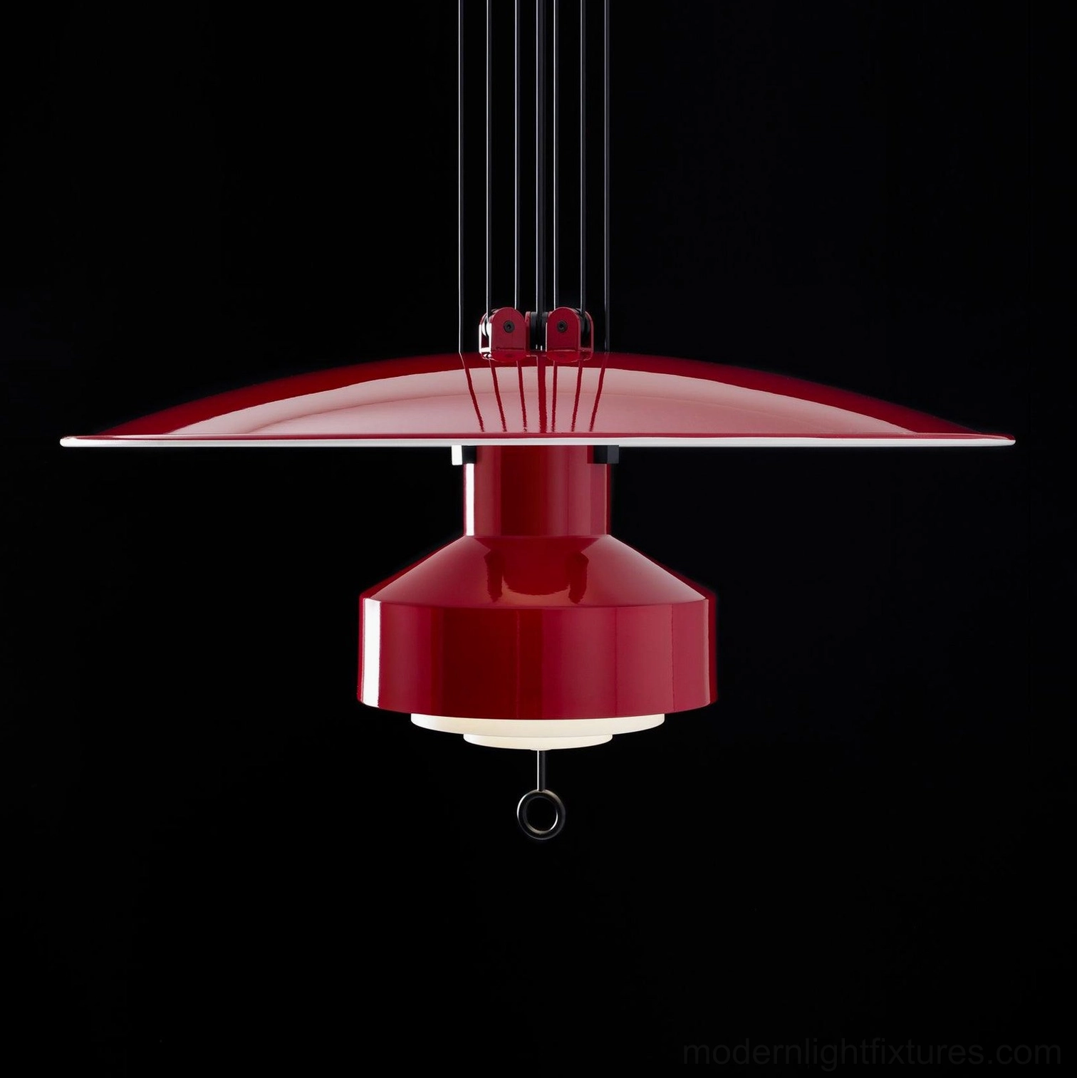 Red disc pendant lamp side view showing suspension cables and polished metal construction