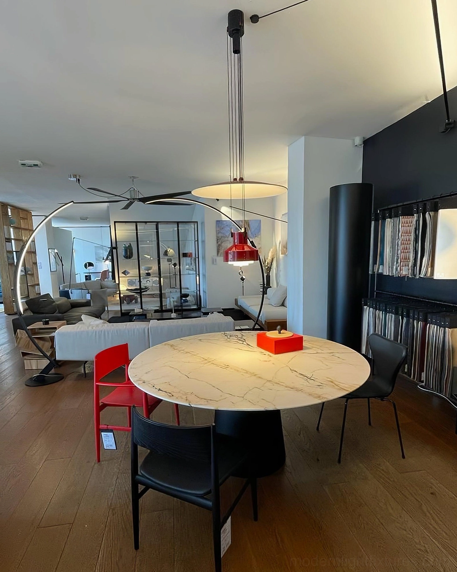 Multiple jeka pendant lamps in various colors creating coordinated lighting design