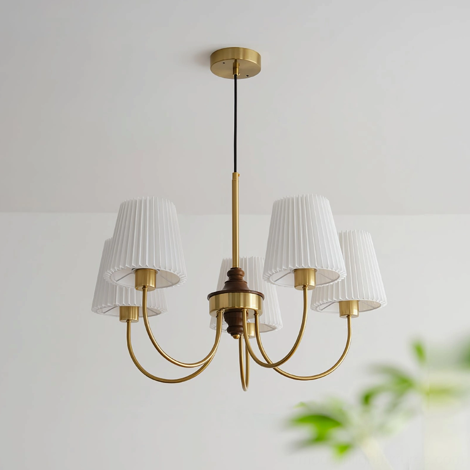 Modern Jeremiah 5-light brass chandelier with curved gold metal arms and white pleated fabric shades in contemporary home