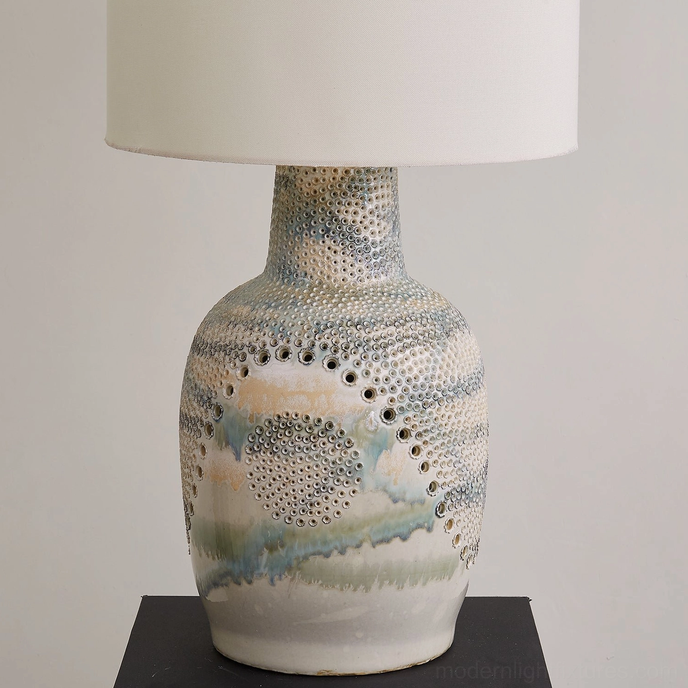 Close-up low-angle view of Jordyn table lamp showing intricate embossed dots and watercolor glaze texture