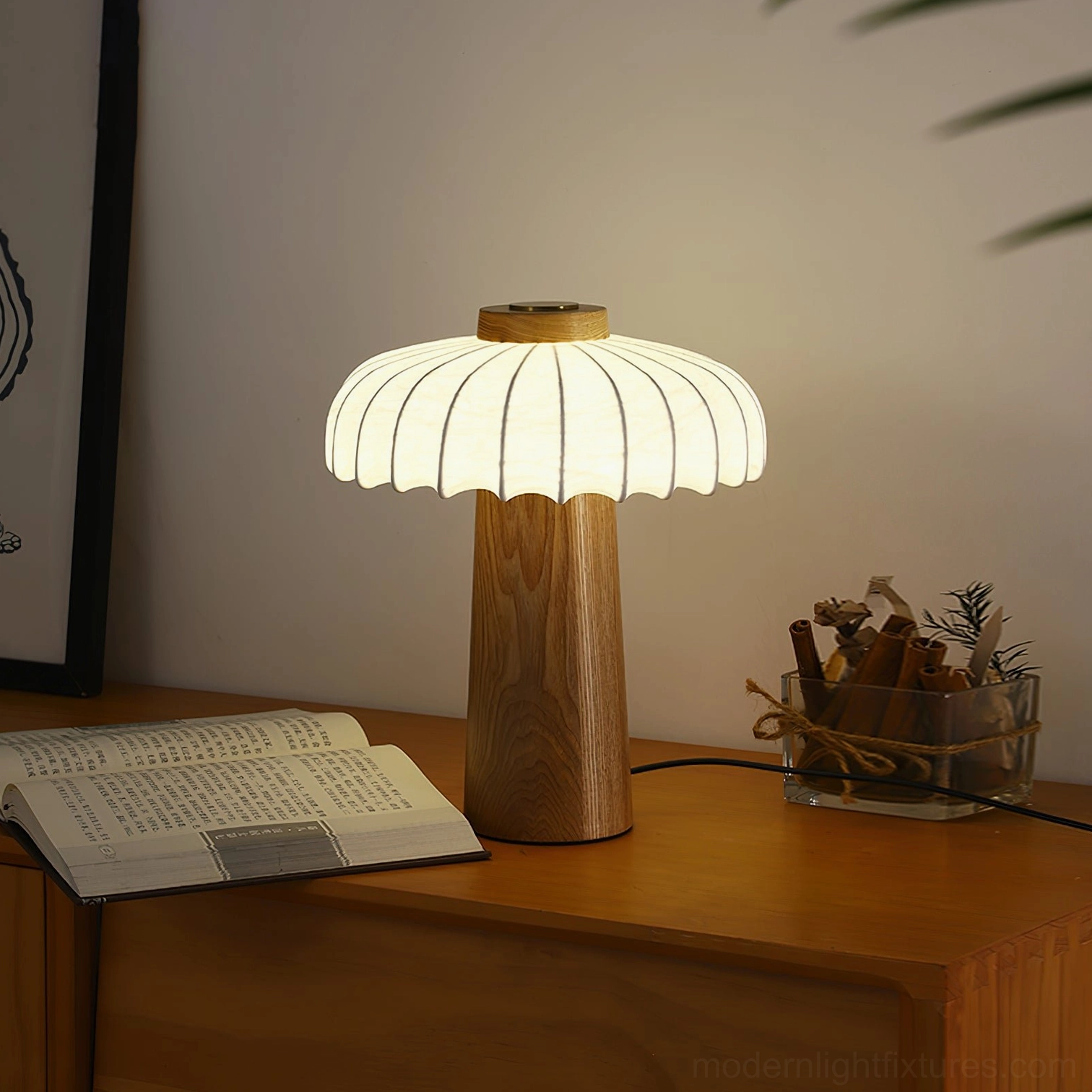 Illuminated Juego wooden mushroom lamp on home office study desk with open book and dried flowers
