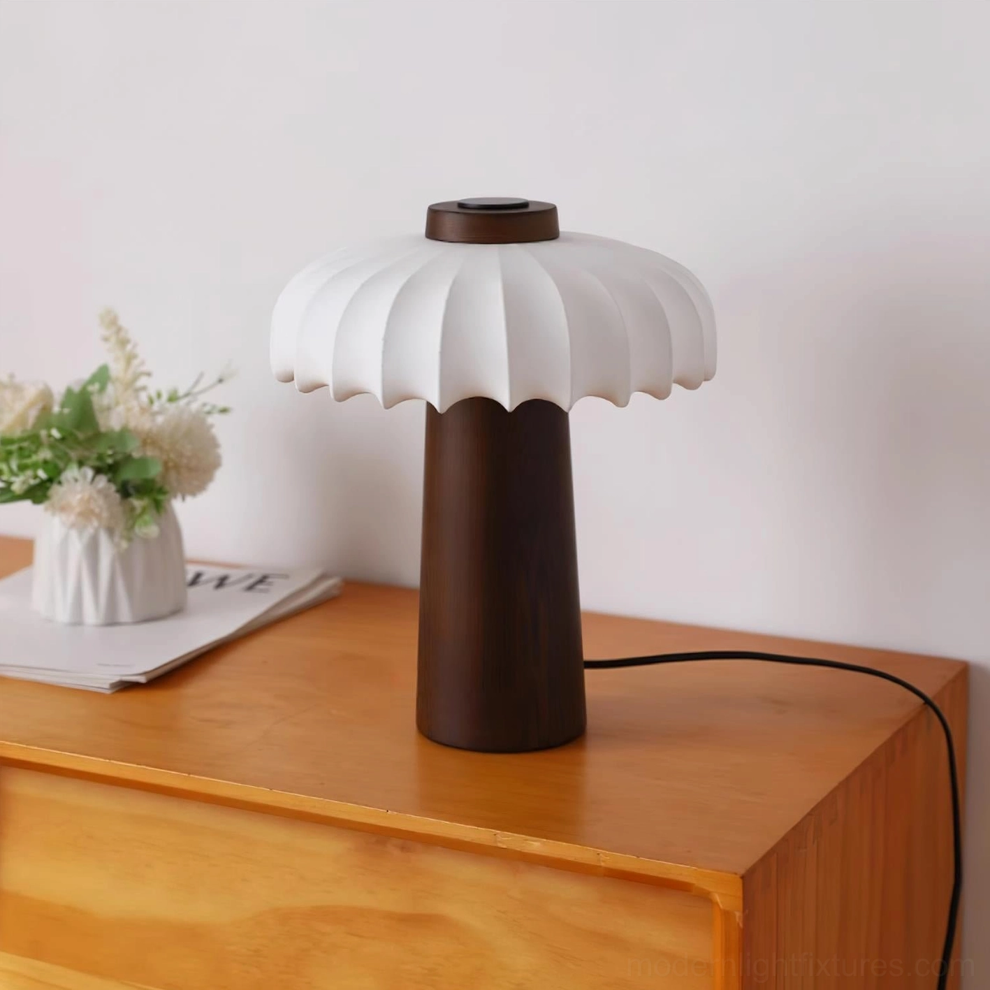 Juego wooden table lamp providing soft diffused light on minimalist nightstand