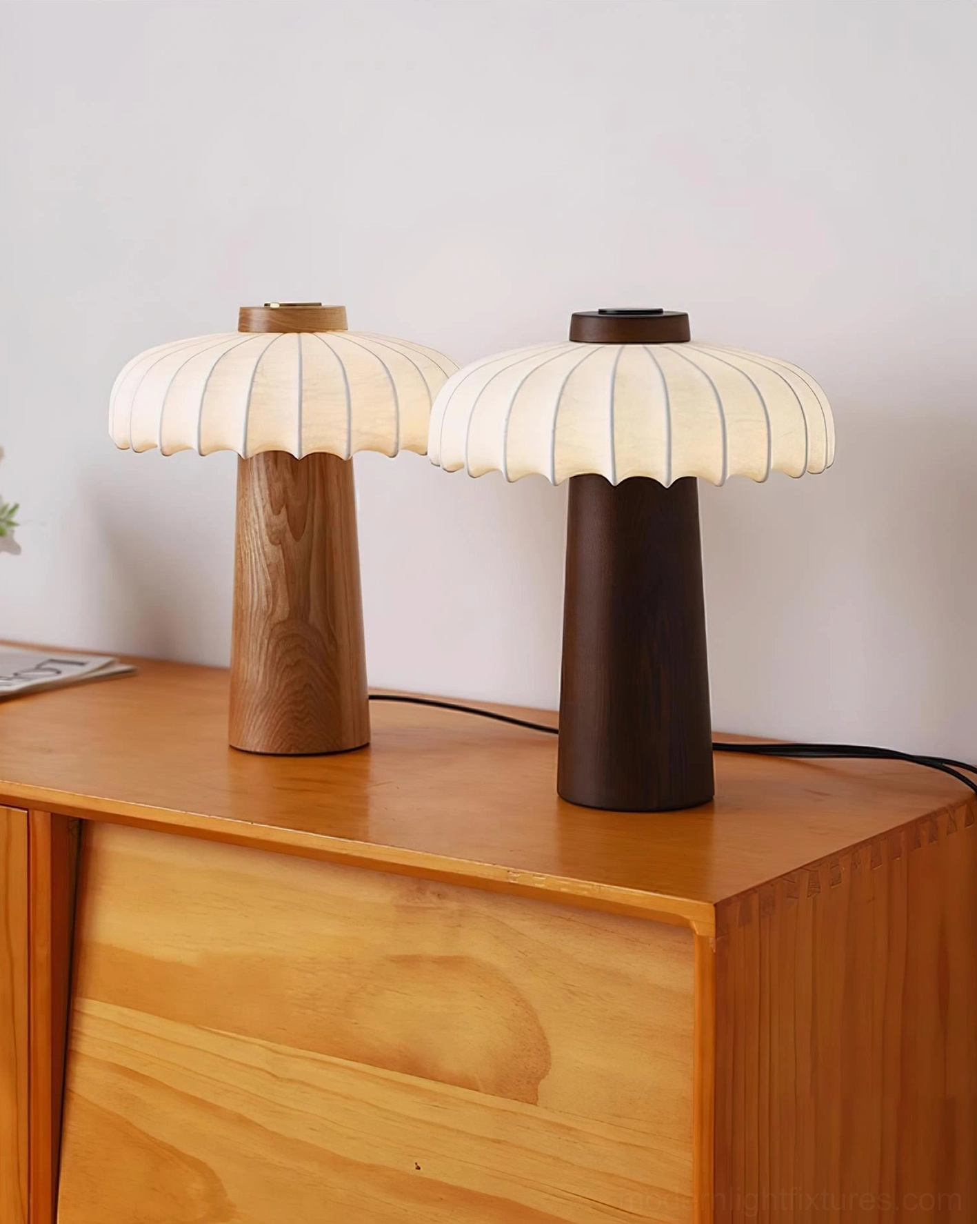 Pair of Juego wooden mushroom table lamps with two wood finish options on dresser tabletop
