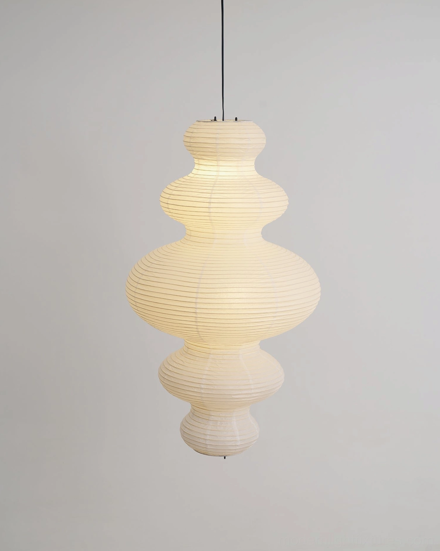 Juni hand-crafted pendant light in home interior - warm paper shade glow
