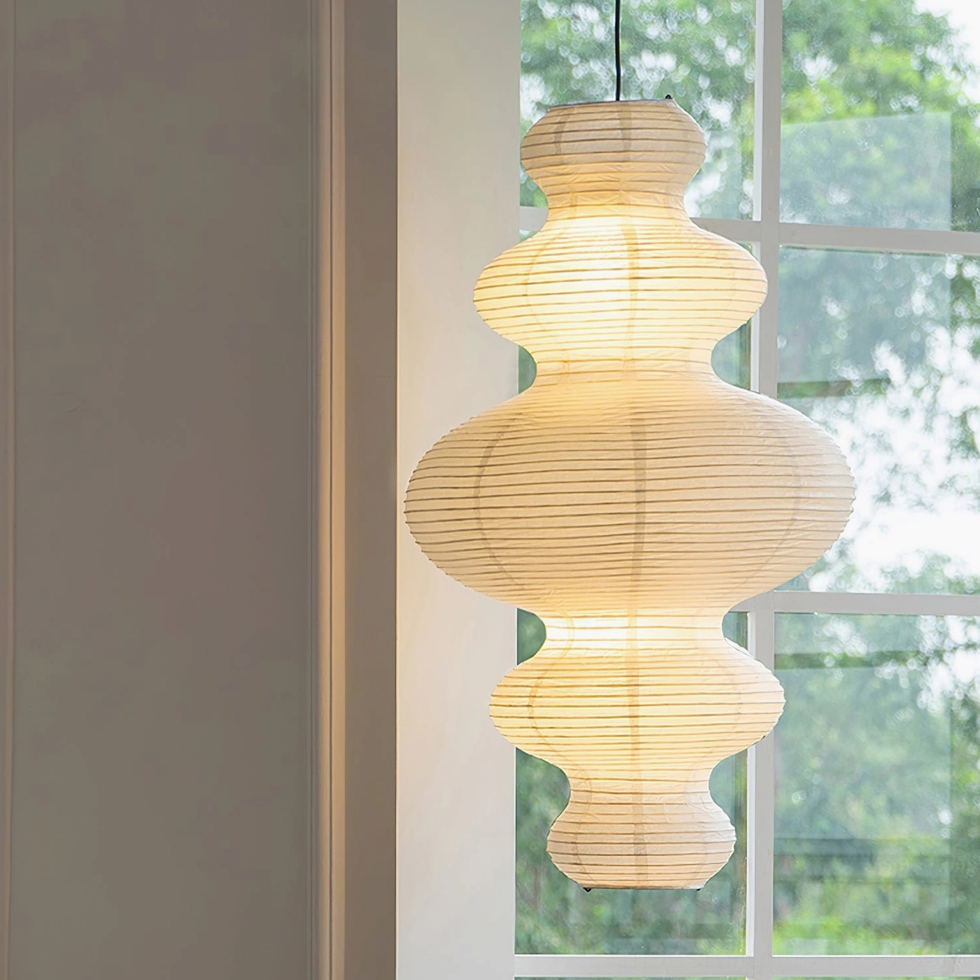 Juni pendant lamp glowing softly in minimalist interior - Japanese design heritage