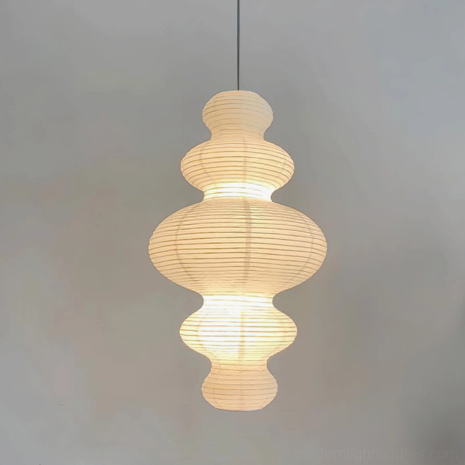 Juni paper pendant lamp illuminated in evening setting - warm soft paper glow