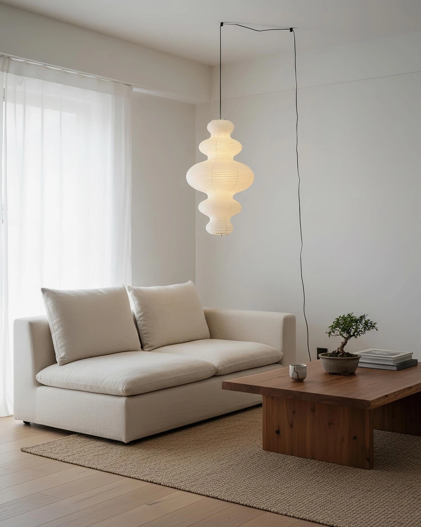 Juni paper pendant lamp illuminated creating warm shadowless light in living space