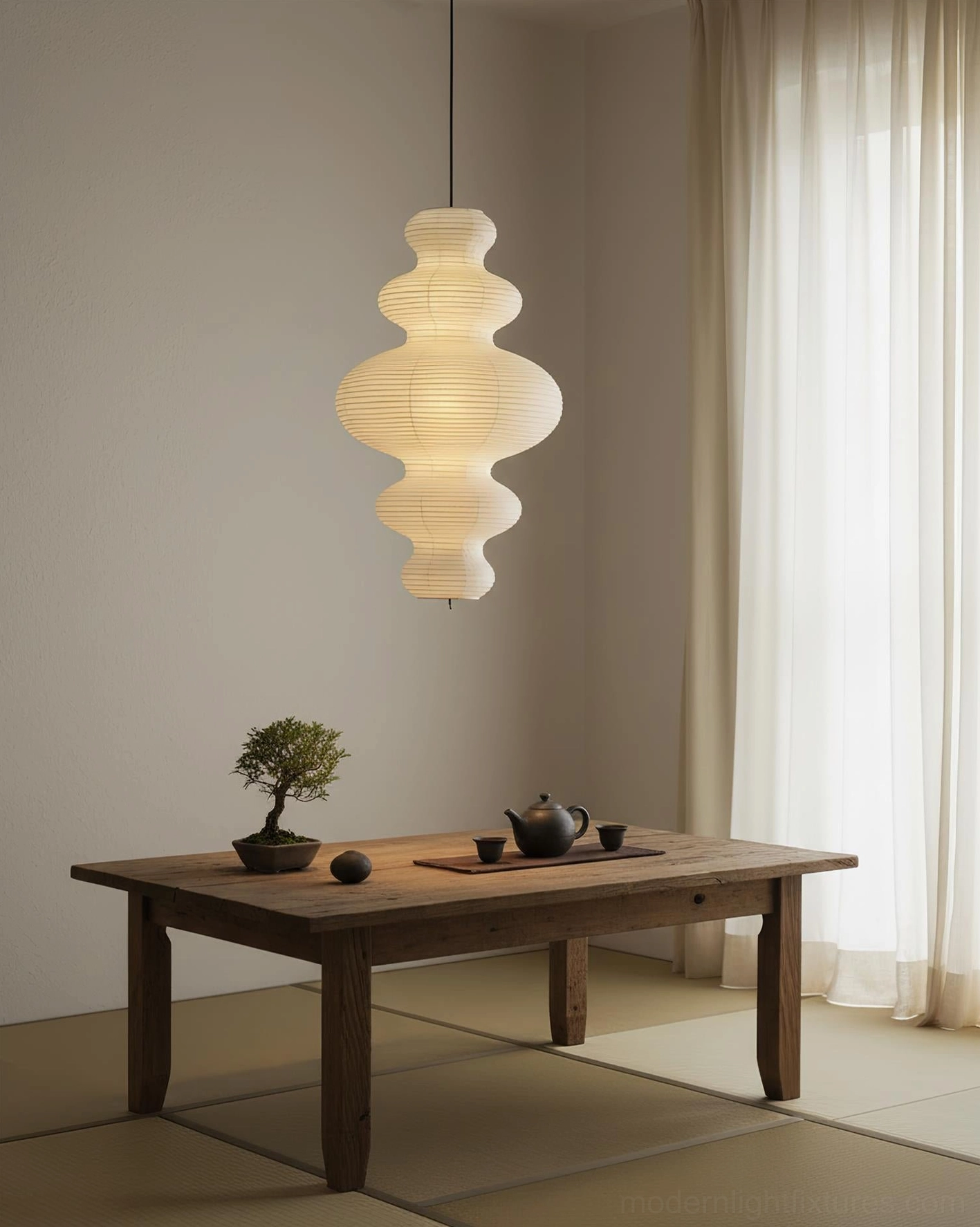 Juni pendant light creating soft atmospheric glow in contemporary living room corner