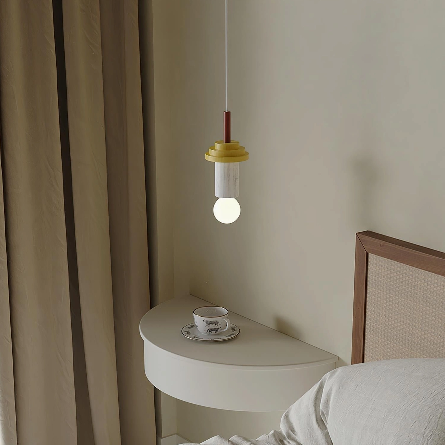 Junit pendant light installed in bedroom bedside area with warm yellow and red tones
