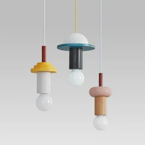 Color-blocked Junit pendant lamps with spherical exposed bulbs on gray background