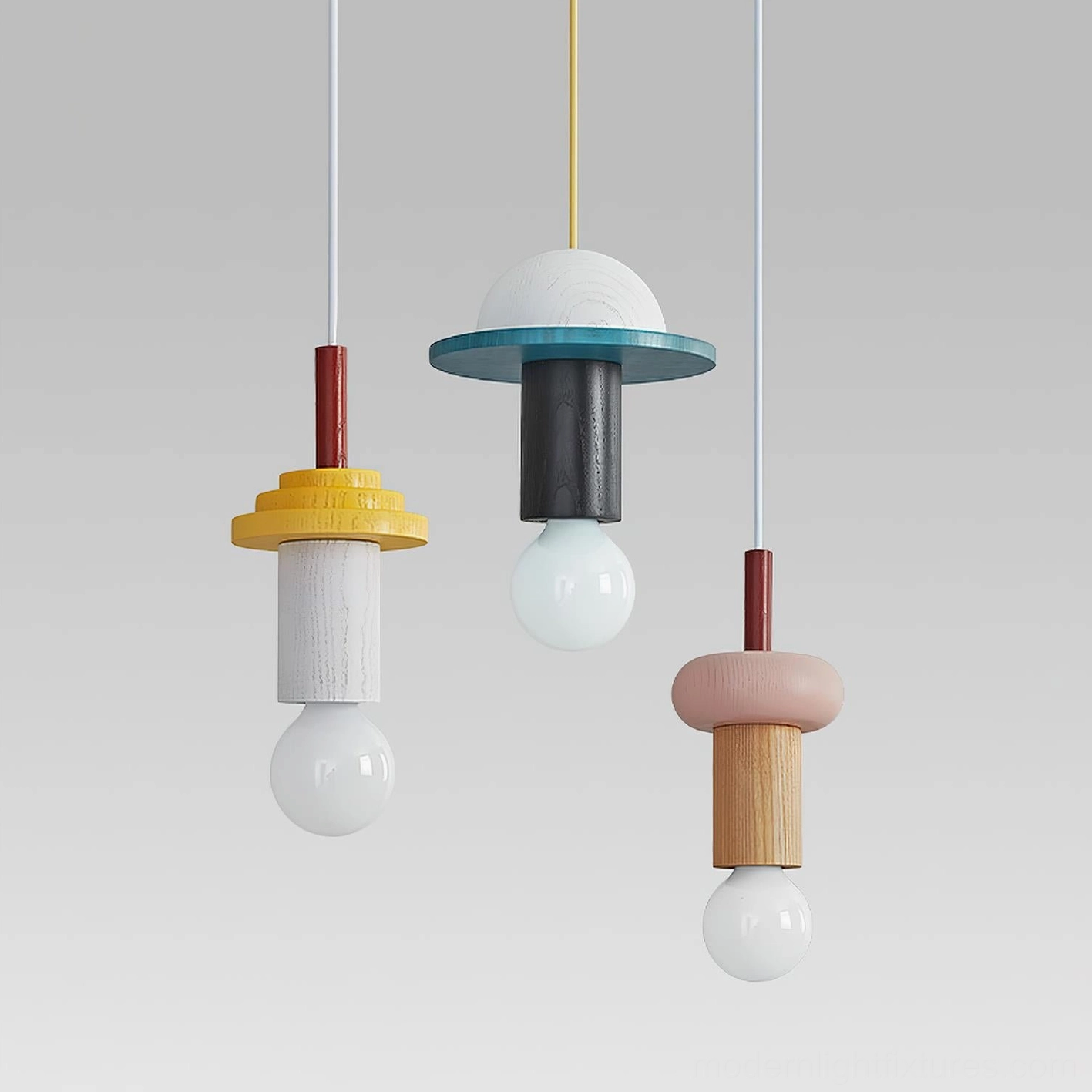 Color-blocked Junit pendant lamps with spherical exposed bulbs on gray background