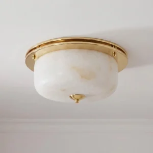 Justice natural alabaster dome flush mount installed on white residential ceiling with brass finial detail visible