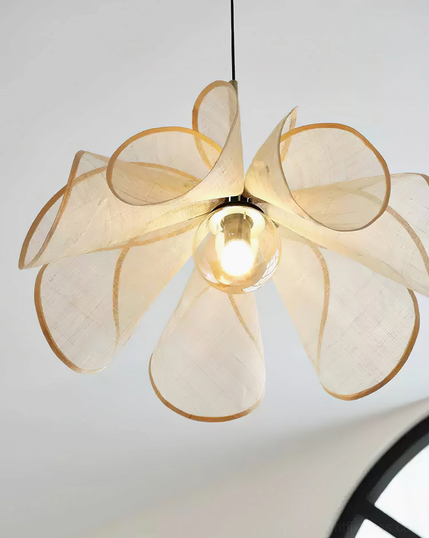Close-up detailed view of Styria Petals jute pendant light showing petal silhouette and glass bulb against neutral background