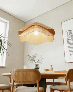 Handwoven jute-cord scalloped pendant light hanging above wooden dining table in Scandinavian interior, warm ambient lighting