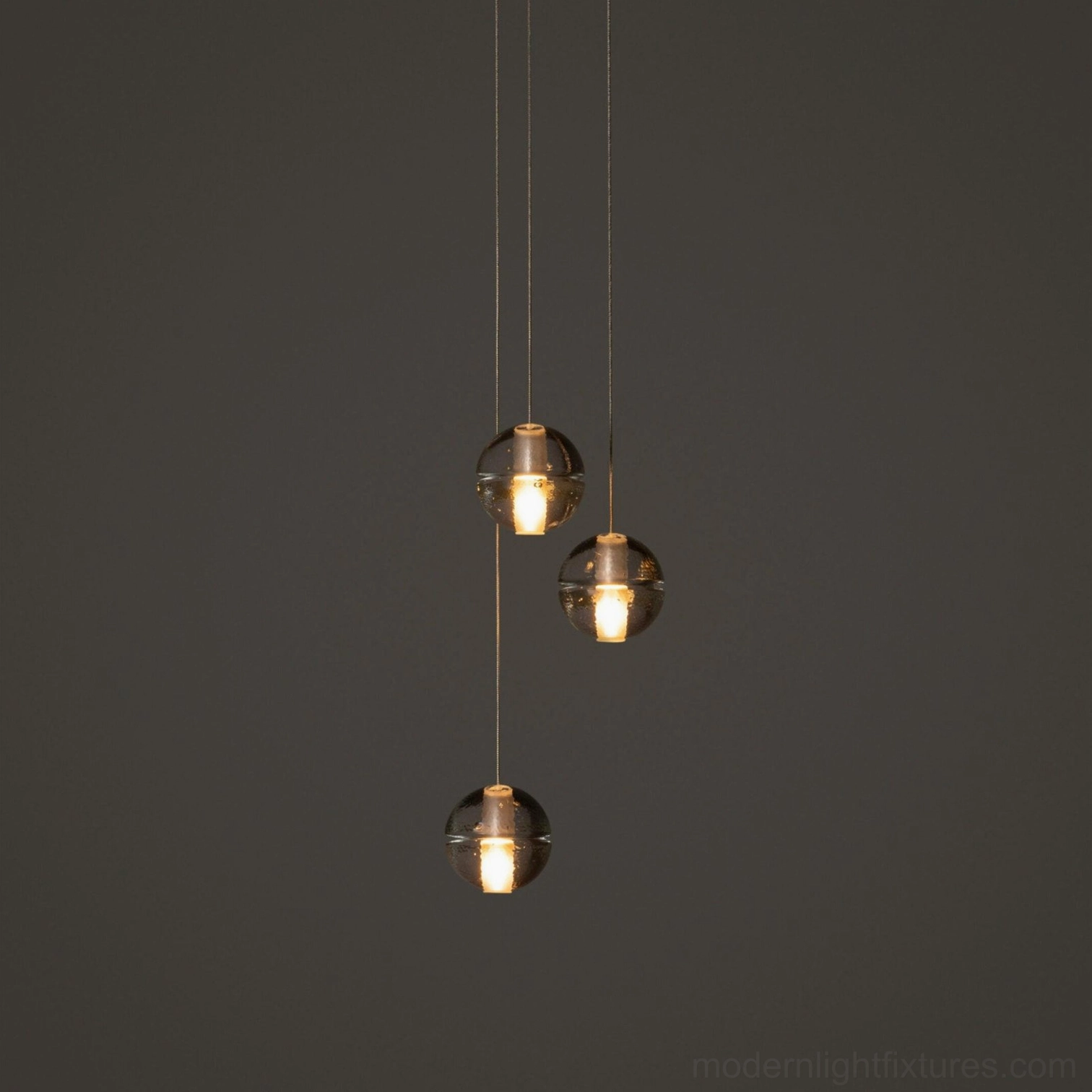 Close-up of K9 crystal pendant heads with clear glass shades and chrome suspension