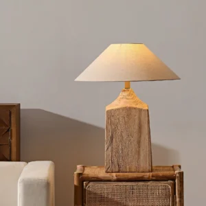 Wooden table lamp with warm ambient lighting in living room setting, creating cozy atmosphere
