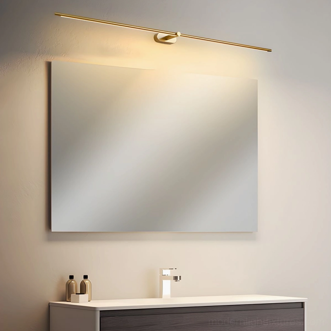 Kady Linear wireless wall sconce mounted above bathroom vanity mirror, brass gold color providing warm light for grooming