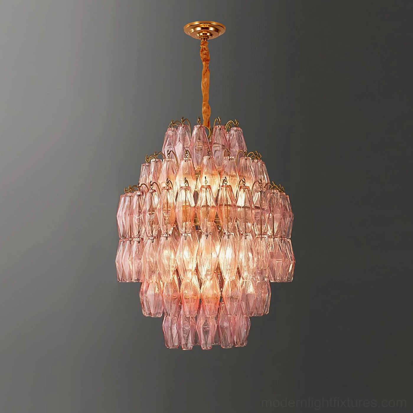 Tiered chandelier with gold metal frame and geometric glass prisms, detailed view of contemporary fixture design