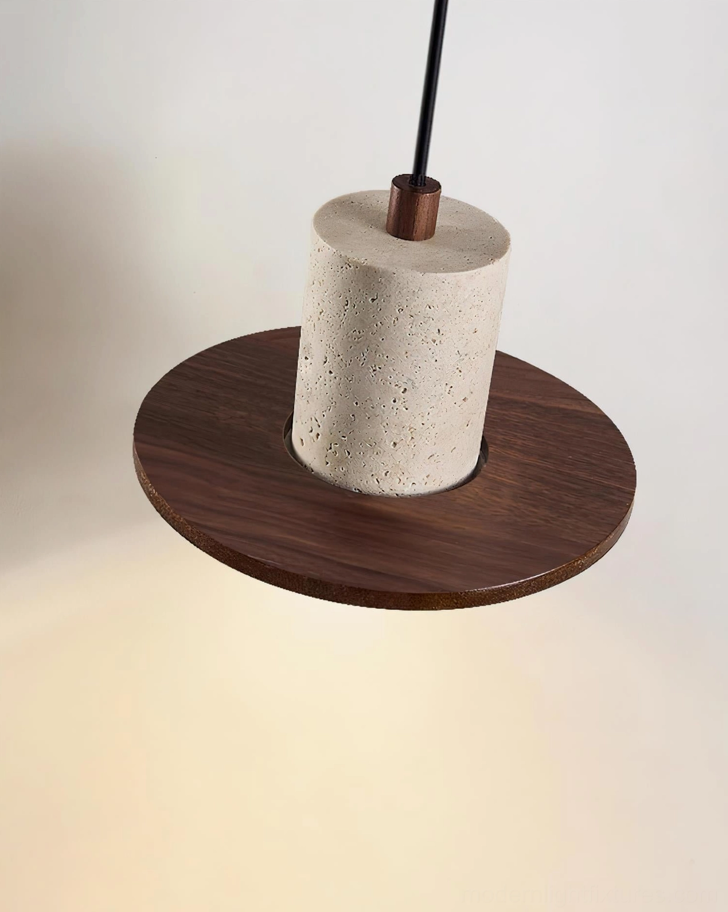 Kalea pendant light low-angle view showing compact cylindrical walnut wood base and travertine shade