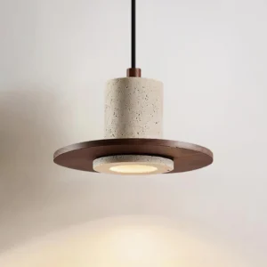 Single head Kalea pendant lamp showing walnut base and travertine stone shade with cast light shadow
