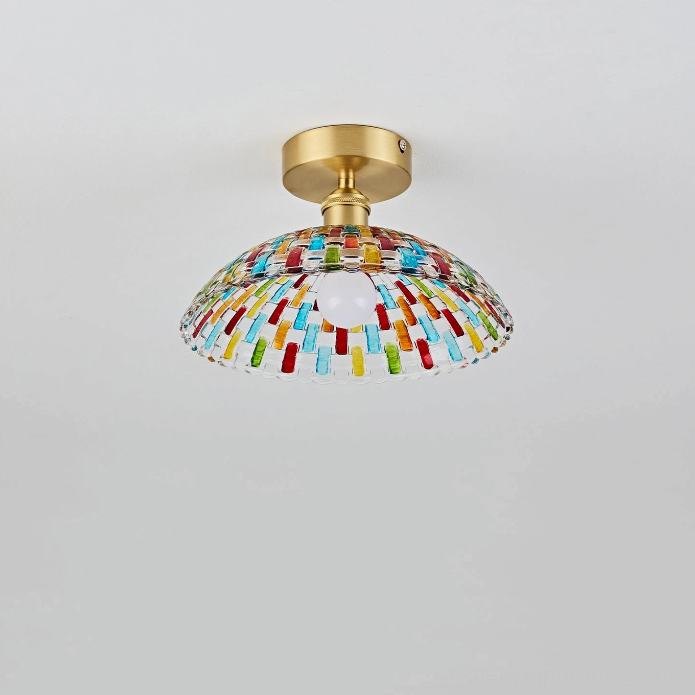 Kaleido mosaic glass ceiling light fixture side low-angle view, curved multicolor glass dome, brass base, unlit exposed bulb