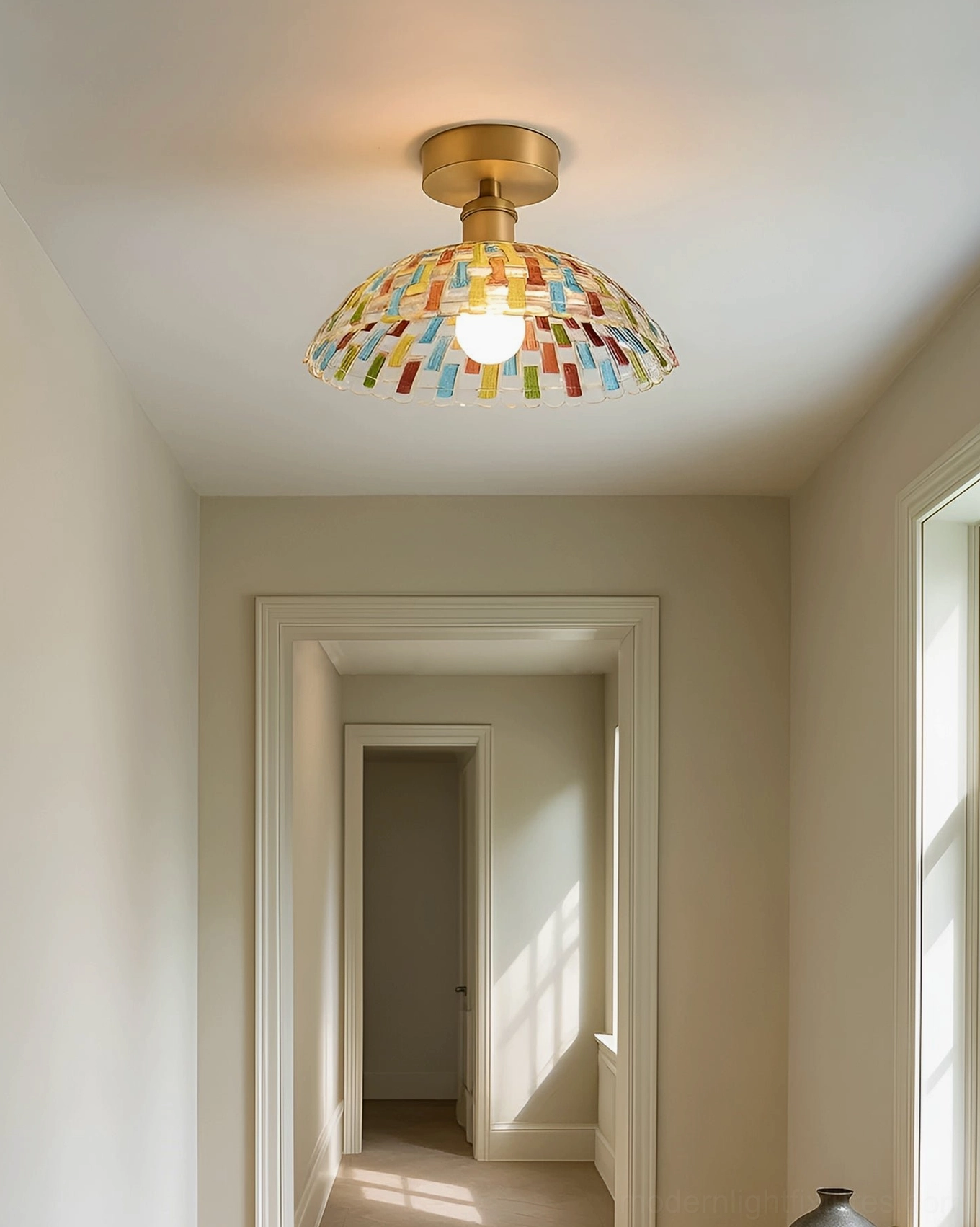 Kaleido brass ceiling light fixture hallway perspective, multicolored glass dome shade, warm neutral wall palette