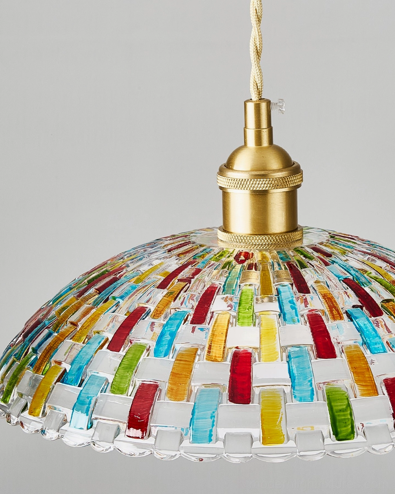 Kaleido stained glass pendant light close-up overhead shot displaying colorful rectangular glass tiles and brass base