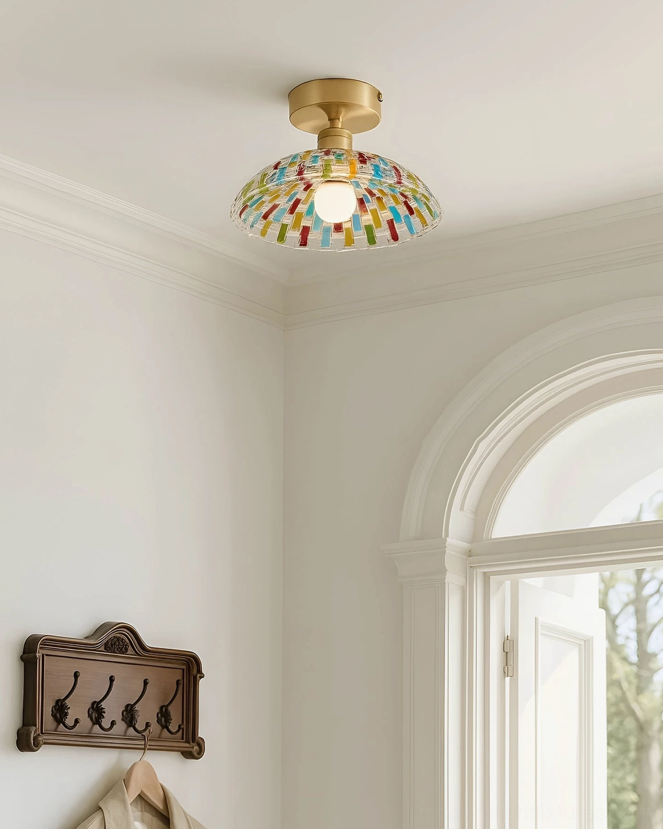 Kaleido hand-cut glass ceiling light in bright residential corner with arched window, mosaic dome brass fitting, neutral interior walls
