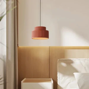 Terracotta Kami pendant lamp hanging in modern bedroom, low-angle perspective with warm interior lighting