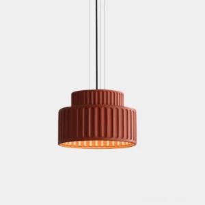 Kami pleated pendant light with brick red matte finish, front studio view showing tiered ribbed cylindrical design