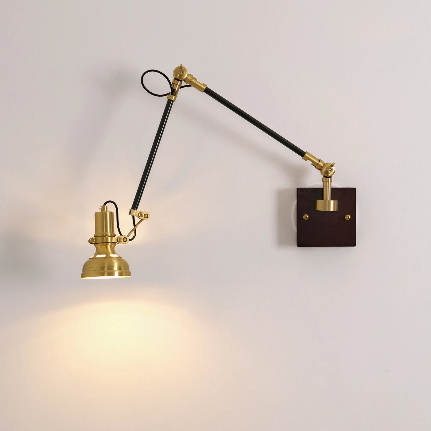 Kane industrial brass wall lamp detail showing articulated swing arm mechanism