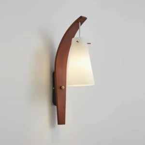 Karo wall sconce three-quarter angle displaying brass hardware accents and conical frosted glass diffuser