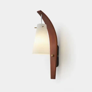Karo mid-century modern wall sconce with curved wood arm and frosted glass shade in walnut finish, front studio view