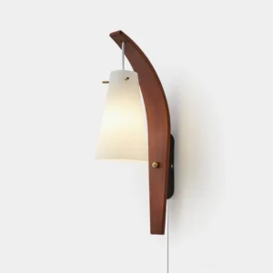 Karo modern plug-in wall sconce with curved walnut wood frame and frosted glass shade, front studio view