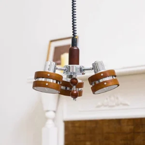 Karry vintage pendant light fixture illuminated in warm living room with fireplace displaying three pendant heads in natural home setting