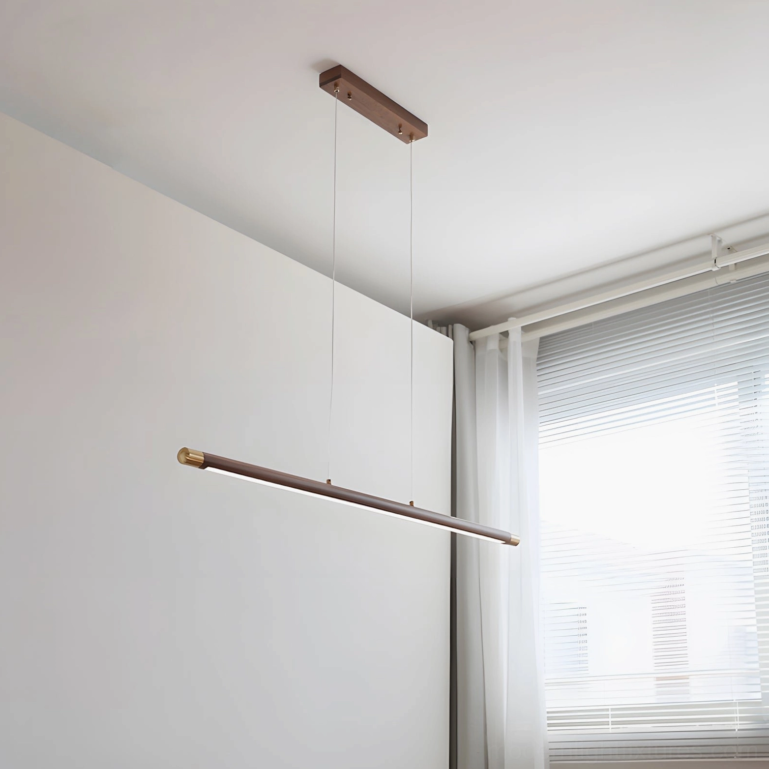 Horizontal linear wood pendant light creating ambient illumination in contemporary residential space