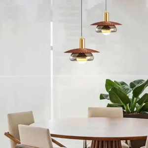 Three-piece Kasa pendant lamp cluster installed above round wooden dining table in modern minimalist room