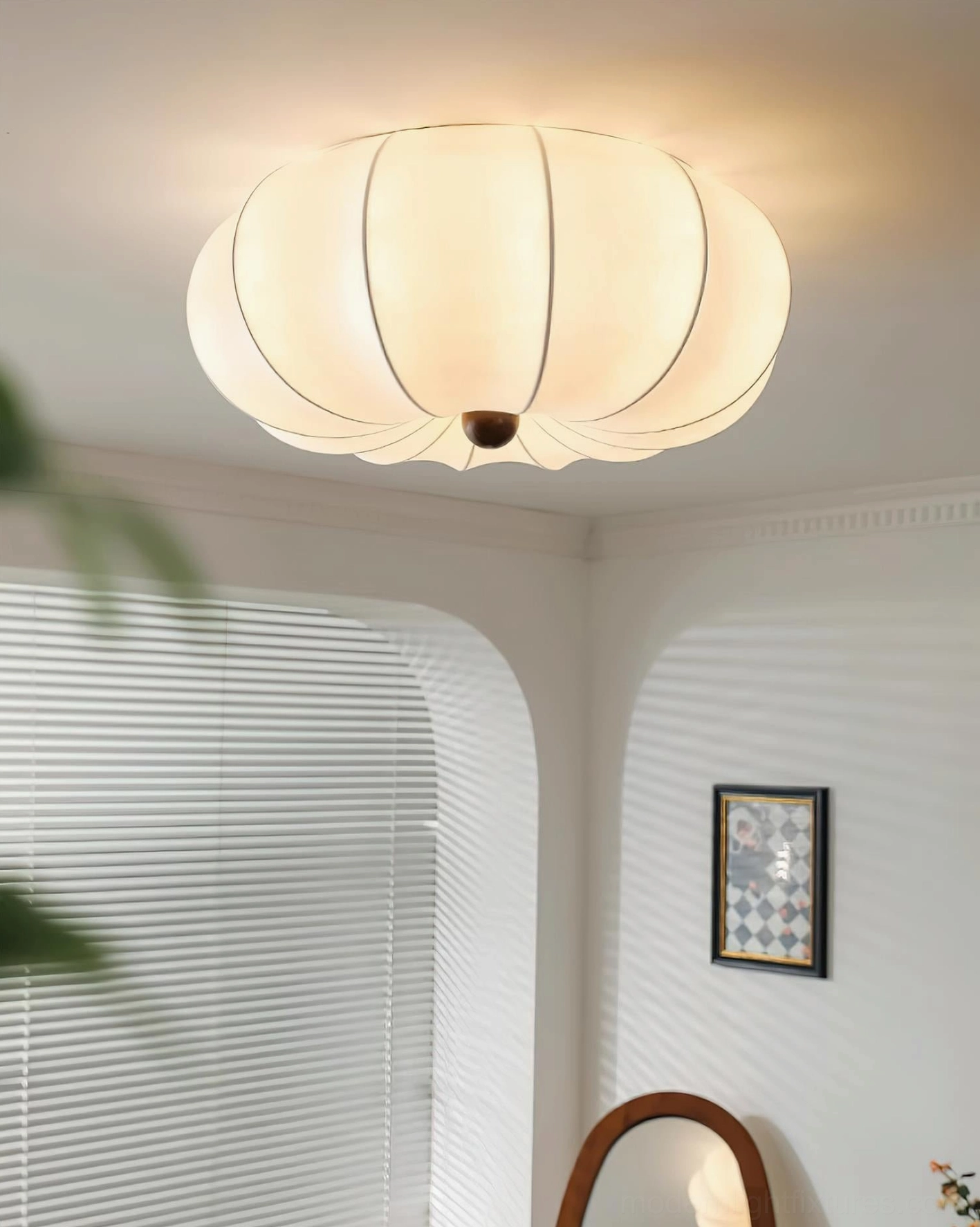 Kateo fabric ceiling light producing warm diffused glow in bedroom nook with natural wood accents