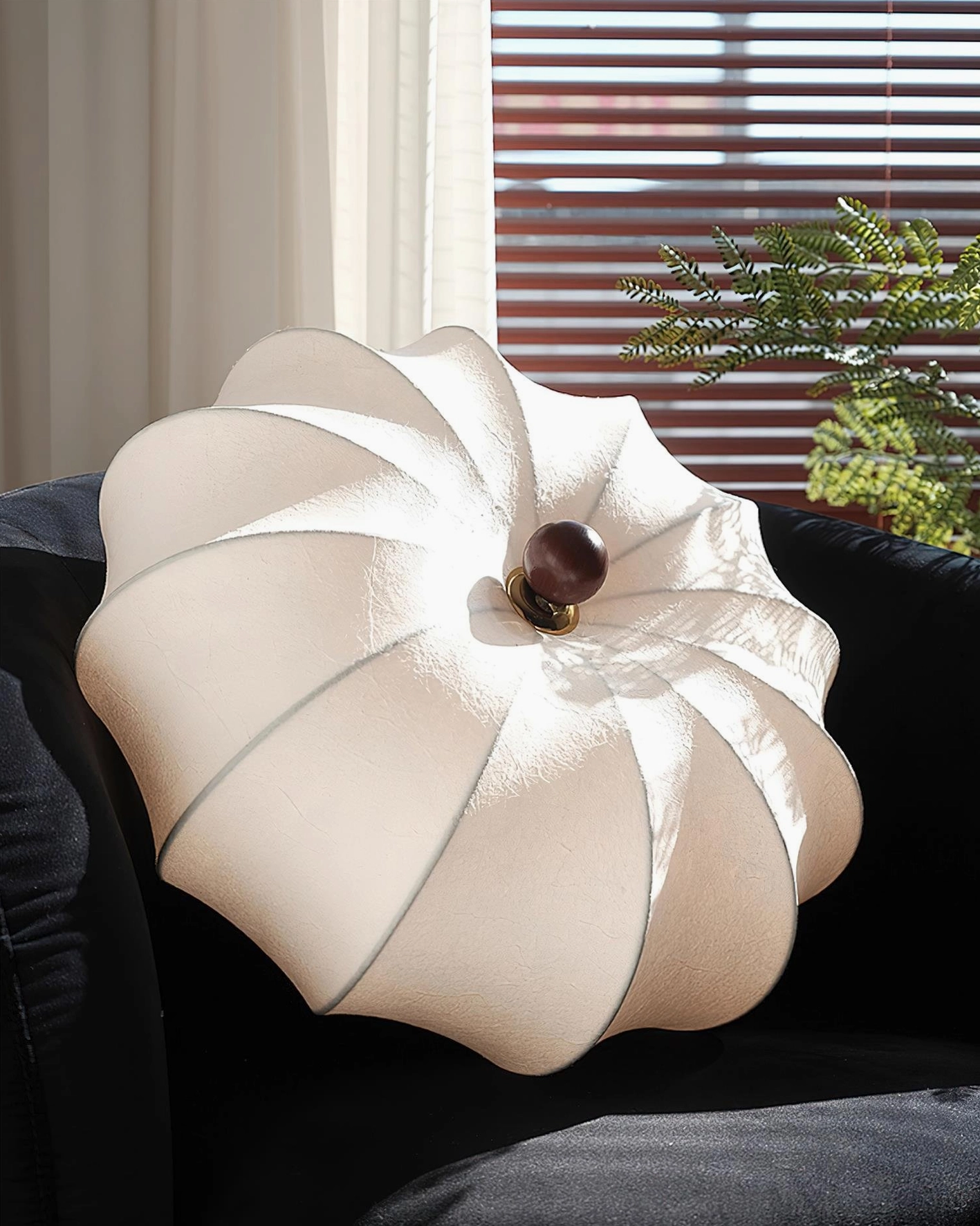 Kateo fabric ceiling light hanging above modern living room sofa with off-white shade and wooden base accent
