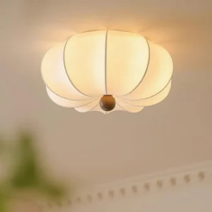 Kateo modern pumpkin ceiling light fixture glowing with warm yellow ambient lighting in interior space