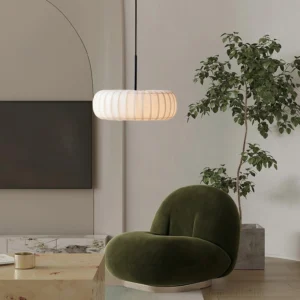 Modern white fabric pendant light in contemporary living room with velvet armchair