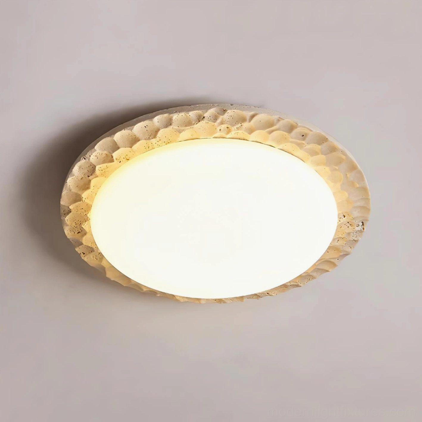 Close-up detail of Kauai travertine ceiling fixture showing honeycomb texture and warm white LED illumination