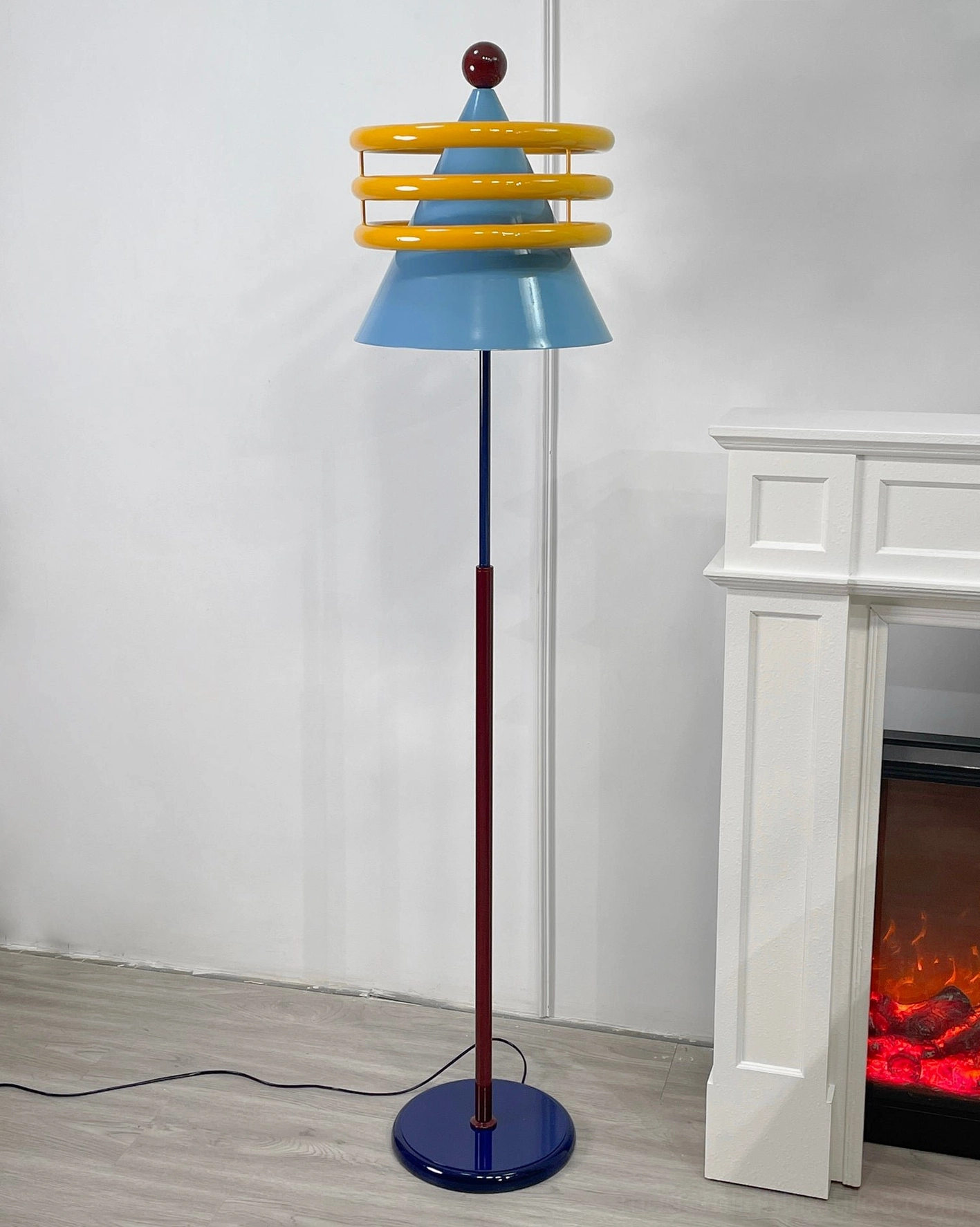 Blue conical shade floor lamp with yellow decorative rings contemporary interior accent piece
