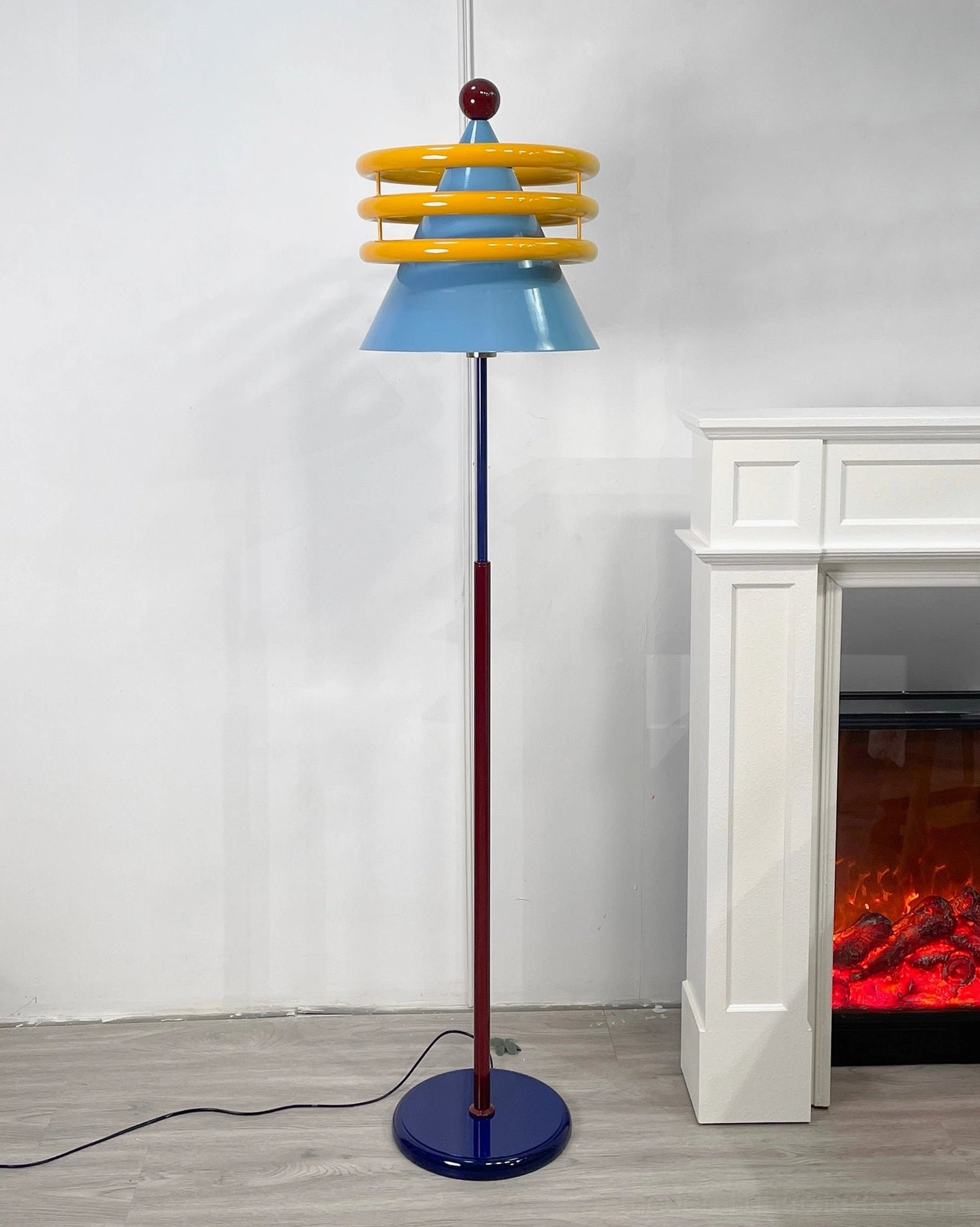 Yellow-ringed blue floor lamp showcasing mid-century modern design influence in home environment