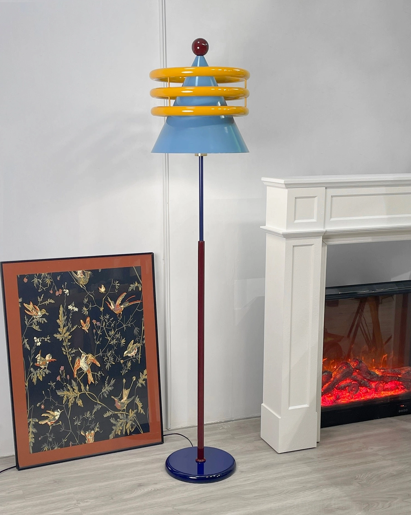 Pop art inspired floor lamp with primary color palette and geometric ring details in modern home