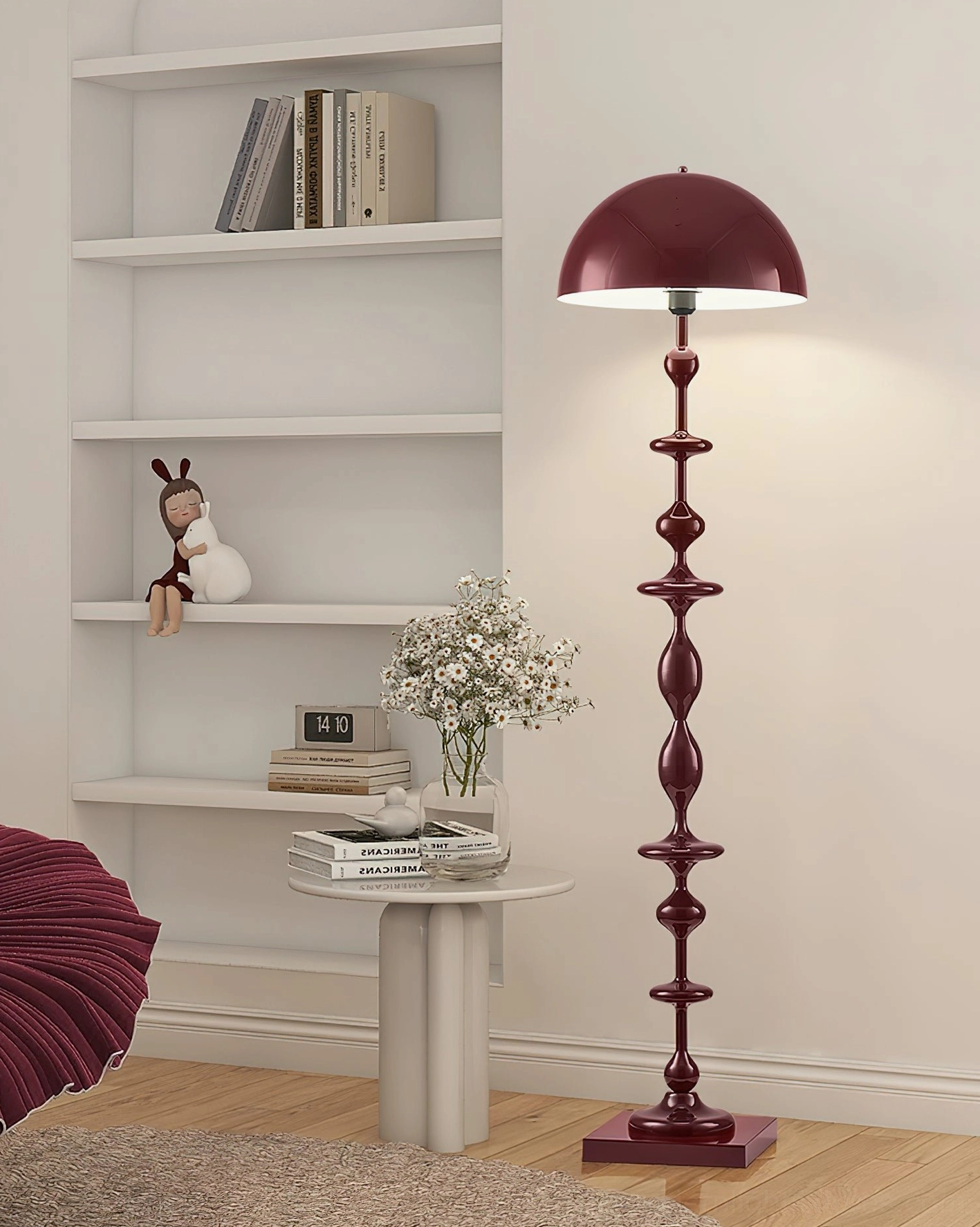 Wine red Keira sculptural floor lamp with stacked bulbous design in minimalist white bookshelf living room setting