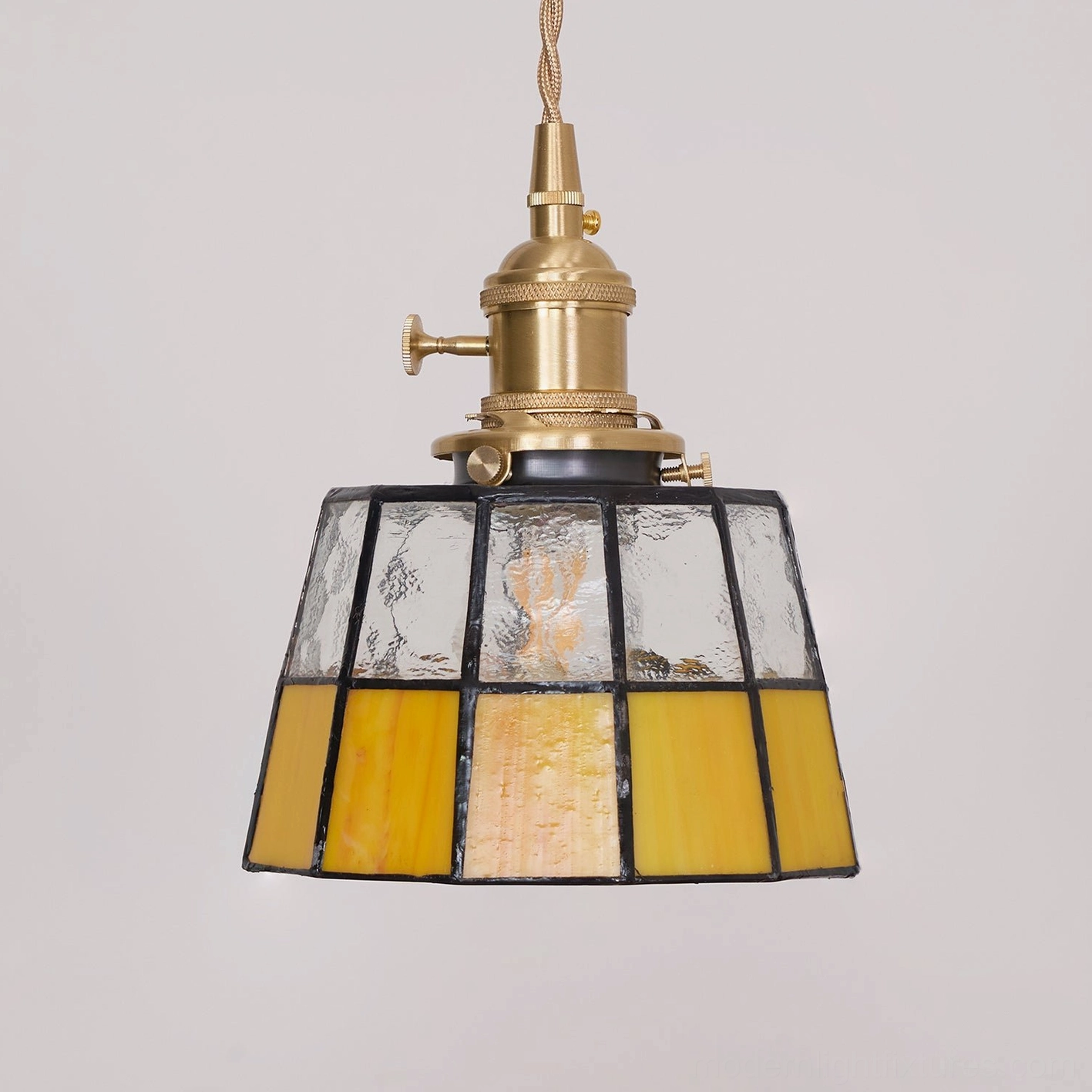Keito stained glass pendant light with alternating clear and amber panels in studio view