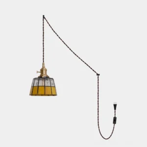 Keito stained glass plug-in pendant light with brass socket, clear textured glass top, and warm amber glass band on white background - front view showing hand-cut leaded glass design